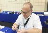 Lang examines coins at the NGC booth