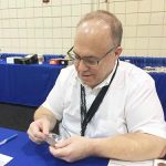 Lang examines coins at the NGC booth