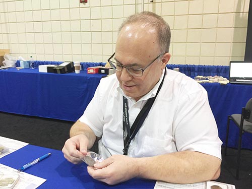 Lang examines coins at the NGC booth