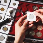 Box with collectible coins and magnifying glass