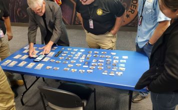 Doug Davis setting up counterfeits display