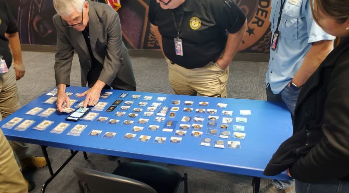 Doug Davis setting up counterfeits display