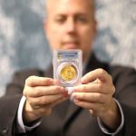 Ian Russell of GreatCollections holds the 1933 Saint-Gaudens double eagle, PCGS MS65.